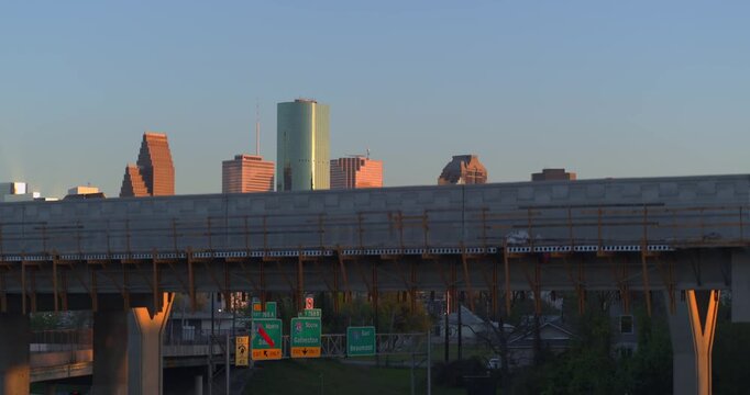 Ascending drone shot of cars on I-45 North freeway reveals downtown Houston