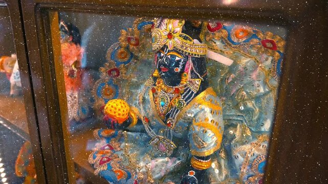 Beautifully adorned with gold and silver statue idol representing Lord Krishna or Radha Krishna black in color, a major deity in Hinduism that represents the unbreakable bond of divine love 