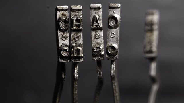 Macro of old typewriter hammers says CHAOS 