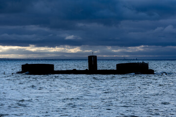 Naklejka premium Silhouette Profile of Shipwreck in Choppy Water