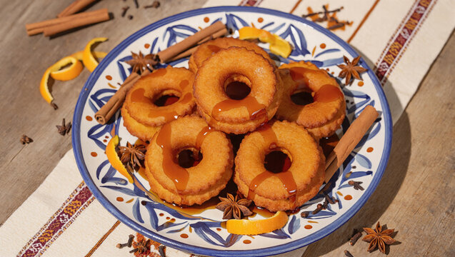 Traditional peruvian picarones with syrup on decorative blue plate with spices