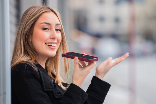 young woman sending a voice message