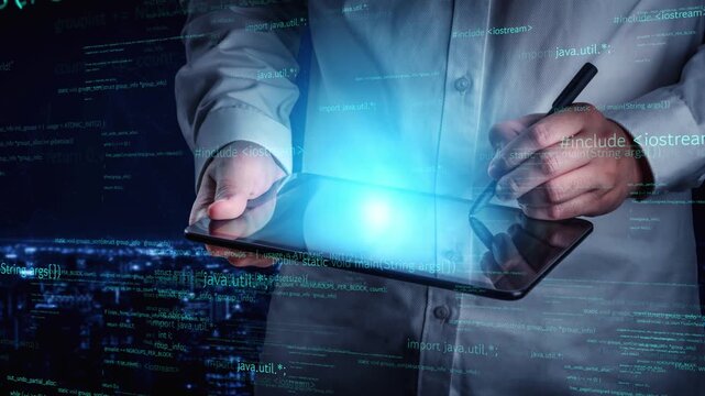 A digital programmer uses a tablet to engage with coding elements in a modern and innovative workspace, highlighting the intersection of technology and creativity. Xenic