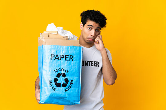 Young Venezuelan man holding a recycling bag full of paper to recycle thinking an idea