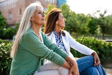 Beautiful senior women meeting outdoors in the city - Mature adult female friends hanging out and having fun, concepts about elderly and quality of life
