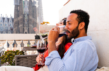 Obraz premium Multiracial beautiful happy couple of lovers dating in Barcelona on a rooftop with amazing city view