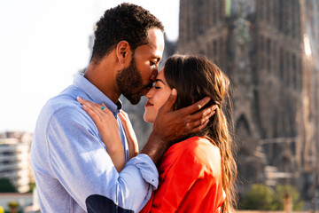 Obraz premium Multiracial beautiful happy couple of lovers dating in Barcelona on a rooftop with amazing city view