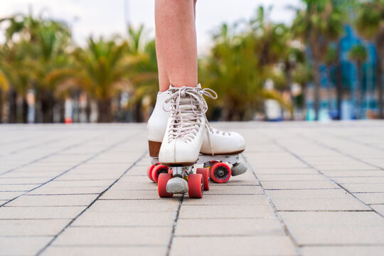 Beautiful red haired young woman with rollerskates having fun outdoors