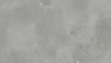 Fototapeta premium Overhead view of a polished light charcoal gray surface with subtle texture and small white specks