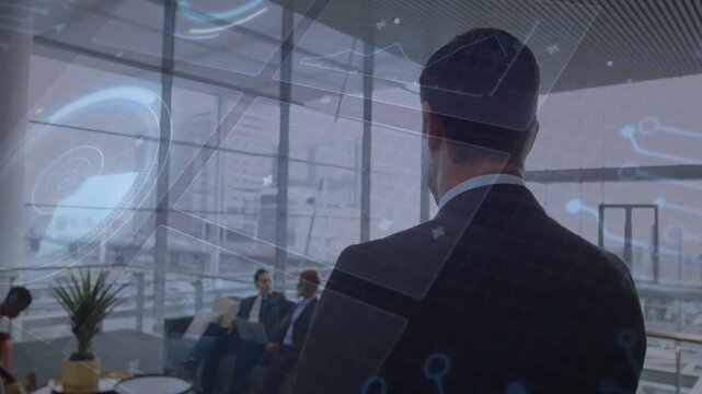 Manager standing in business lounge, peer pointing at laptop causing circuit overlay rising