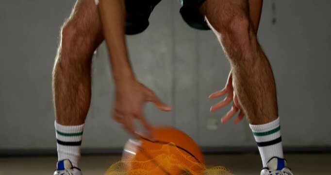 Male player dribbling orange ball entering, doing crossover as gold spark tracking hands for sports