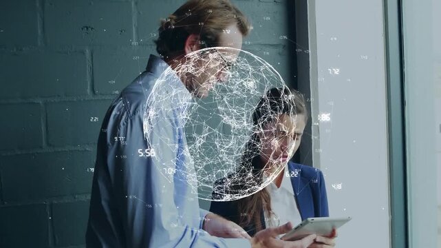 Man pointing tablet sparking animated globe overlay while woman tapping tablet reviewing tech data