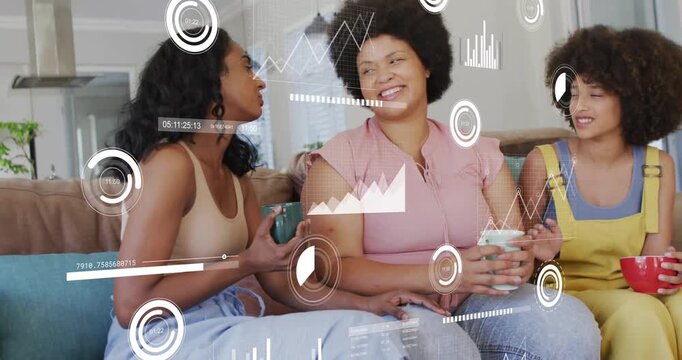 Left woman leaning forward and speaking, women on sofa bonding as data HUD charts tracking gestures