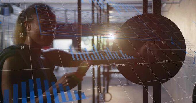 Adult woman following phone cue, tapping wall sensor pad while analytics updating fitness metrics