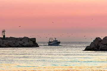 Fishing boat leaving Sciacca harbor at sunset © Luc V. de Zeeuw