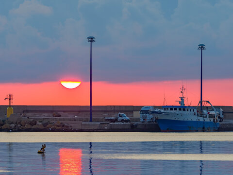 Fishing boat in Mazara del Vallo harbor at sunset