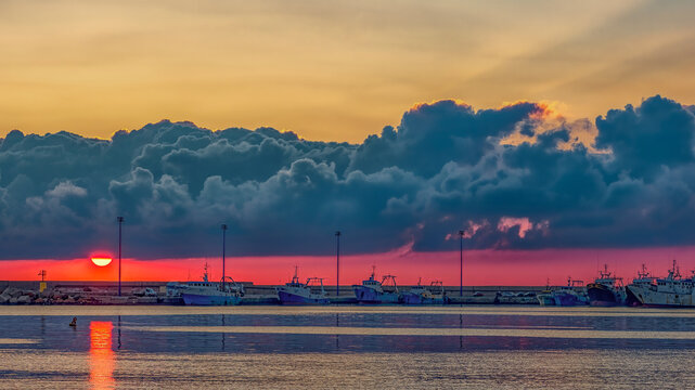 Sunset over fishing boats in Mazara del Vallo harbor