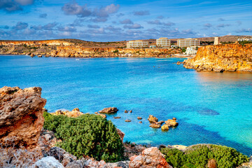 Obraz premium Sea lagoon and hotels on Malta beautiful natural coast, Golden Bay.