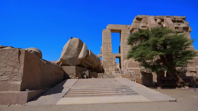 Ruins of Ramesseum mortuary temple with giant Ramesses II Osiride statues. It is located in the Theban necropolis in Upper Egypt, across the River Nile from the modern city of Luxor. Egypt.
