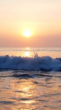 Serene Golden Sunset over calm ocean waves with sun reflection ideal for travel vlogs and meditation backgrounds Vertical. Video. Portrait Orientation.