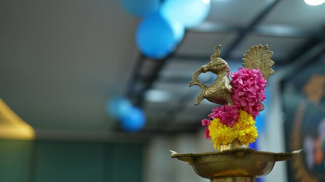 Closeup of Bird-Shaped lamp Adorned with Flowers placed on stage for inauguration of event