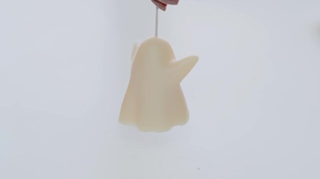 Handheld White Ghost Candle Hanging by Wick Minimal Halloween Decoration and Seasonal Party Prop