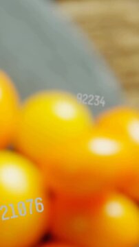 Vertical video: Camera shifting right focusing tomatoes on slate, digits floating showing food ad