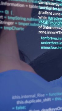 Vertical video: Woman reclining tapping phone causing code scrolling and revealing software