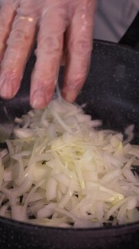 When preparing the vegetable base for the soup, the cook mixes finely chopped onions in a saucepan
