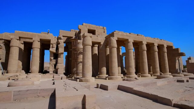 Ruins of Ramesseum mortuary temple with giant Ramesses II Osiride statues. It is located in the Theban necropolis in Upper Egypt, across the River Nile from the modern city of Luxor. Egypt.
