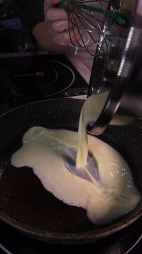 Omelet preparation. Beat the eggs to make breakfast