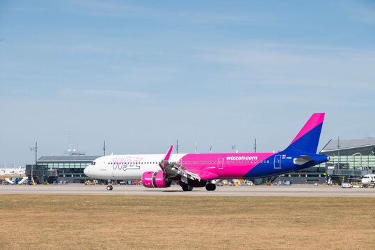  Poland, Gdansk March 28, 2026,  A pink and blue Wizz Air Airbus A321 aircraft taxiing on the runway at Gdansk Lech Walesa Airport  GDN in Poland under a clear sky.