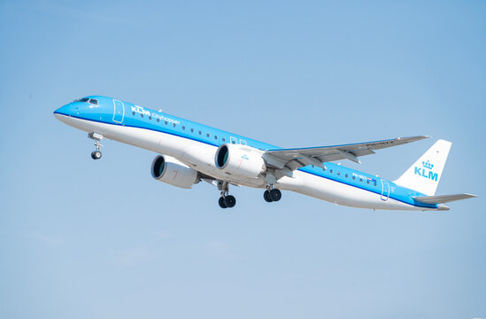    Poland, Gdansk March 28, 2026,  A blue and white KLM Cityhopper Embraer 195-E2 aircraft climbing into the clear blue sky after takeoff from Gdansk Airport GDN in Poland.