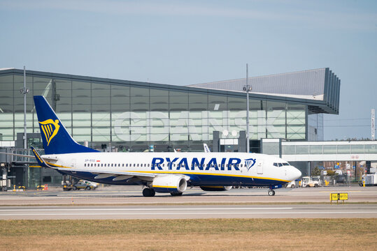   Poland, Gdansk March 28, 2026,  A Ryanair Boeing 737-800 aircraft taxiing on the tarmac at Gdansk Lech Walesa Airport GDN in Poland, with the main terminal building in the background.