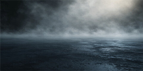 Dramatic dark storm clouds gather over a moody blue sea where natural light pierces through the heavy rain and thick fog to create an abstract heaven against the deep black ocean water © Julya