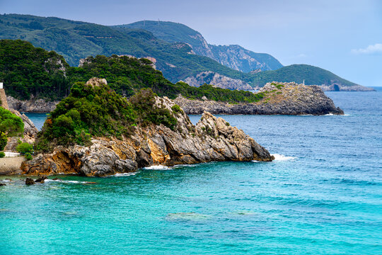 Rocky green coast Corfu with azure water, Ionian Sea, Greek natural coast landscape.
