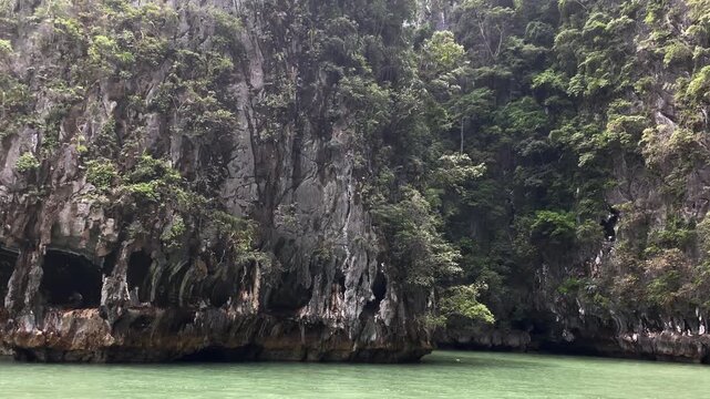 Scenic view of green tropical jungle mountains and coastline in Phuket Thailand, lush natural landscape.