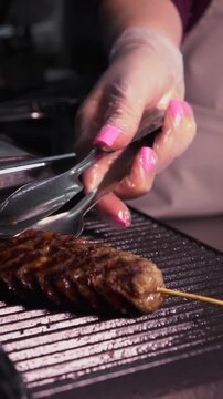 Cooking a steak. A professional chef prepares delicious meat on a hot grill.
