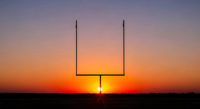 Silhouette of American Football Goal Post at Sunset.
