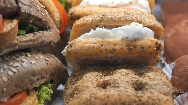 Freshly prepared gourmet sandwiches on display in deli, perfect for a quick and tasty meal.