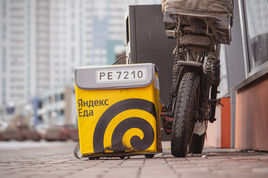 Krasnoyarsk, Russia 19 03 2026: Yandex Eda branded delivery bag close view with bicycle detail, Russian food delivery identity and urban service realism concept