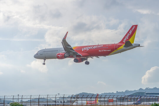 Phuket Thailand 25 11 2025: An aircraft landing at Phuket HKT Airport with a released landing gear of VietJet Air or its subsidiary Thai Vietjet Air Airbus A321-211 with registration number HS-VKR.