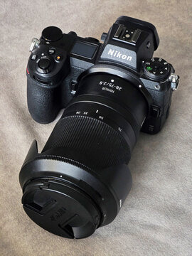 High angle view of a Nikon Z6 II mirrorless camera and Nikkor 28-75mm f/2.8 lens with lens cap, highlighting the grip and top control layout, Tokyo, Japan, Asia.
