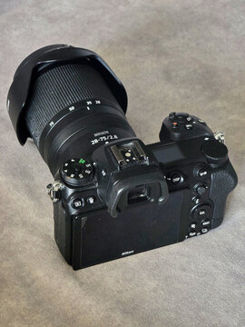 Rear view of a Nikon Z6 II mirrorless digital camera with a Nikkor 28-75mm f/2.8 lens and lens hood attached, showing control buttons and LCD screen, Tokyo, Japan, Asia.