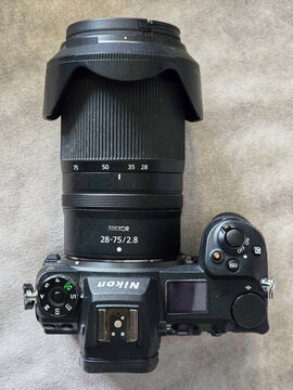 Top down view of a Nikon Z6 II mirrorless camera body paired with a Nikkor 28-75mm f/2.8 lens, showing the top display and focal length markings, Tokyo, Japan, Asia.