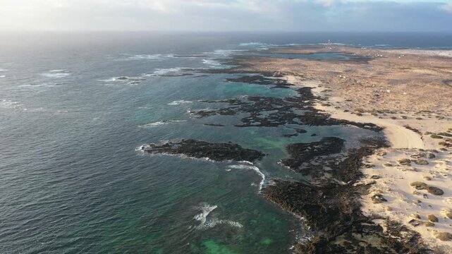 Aerial view of Fuerteventura coast between La Barra islets and Los Islotes with El Toston lighthouse in background