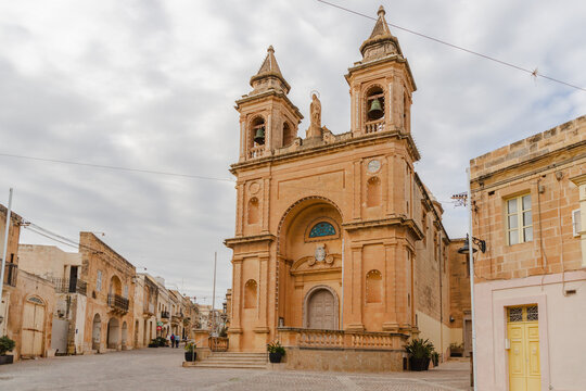View of the Parish Church of Our Lady of Pompei, a stunning golden building standing proudly in the heart of the town, Marsaxlokk, Malta.