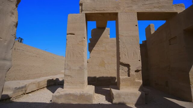 Ancient painted walls and ceiling with gods figures, hieroglyphics and cartouches inside Seti I temple, Luxor Egypt.