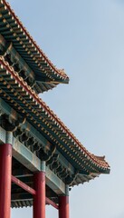 Obraz premium Traditional East Asian Pagoda Roof with Red Pillars and Green Tiles