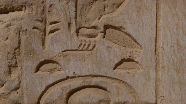 Close-up of detailed hieroglyphic rows with cartouches carved in stone lintel at Seti I temple Luxor Egypt.